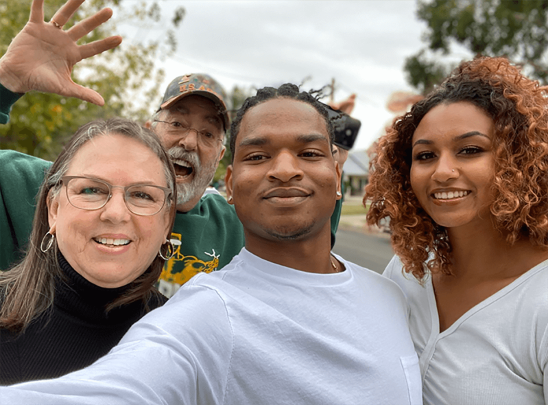 Wanda and Lonnie Dench standing next to Jamal Hinton and Mikaela