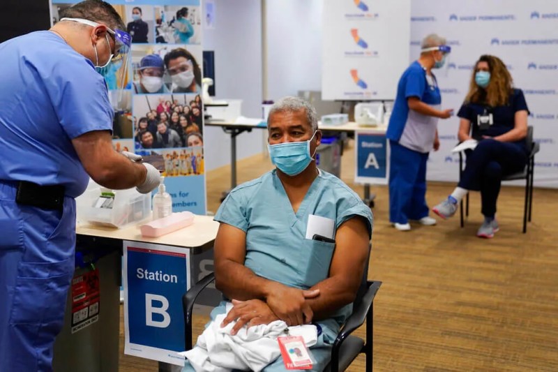 doctor getting COVID-19 vaccine