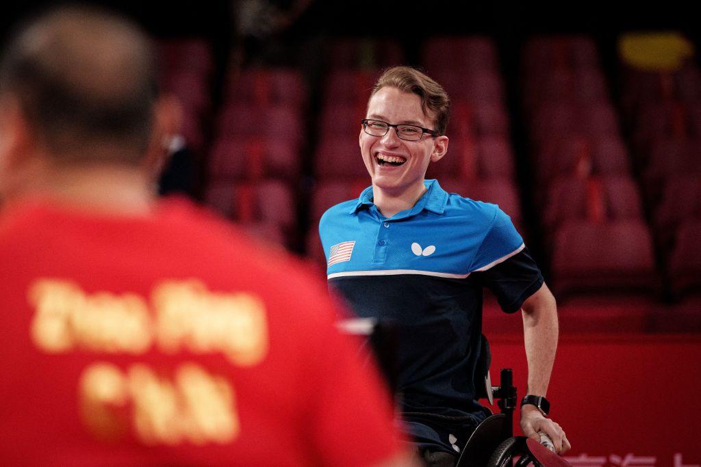 Jenson van Emburgh of the US (R) reacts while playing against China during the men's table tennis team quarter-final (class 3) at the Tokyo 2020 Paralympic Games at Tokyo Metropolitan Gymnasium in Tokyo on August 31, 2021. (Photo by Yasuyoshi CHIBA / AFP) (Photo by YASUYOSHI CHIBA/AFP via Getty Images)