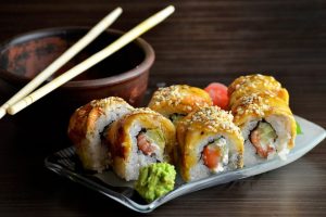 A plate of sushi and chopsticks.