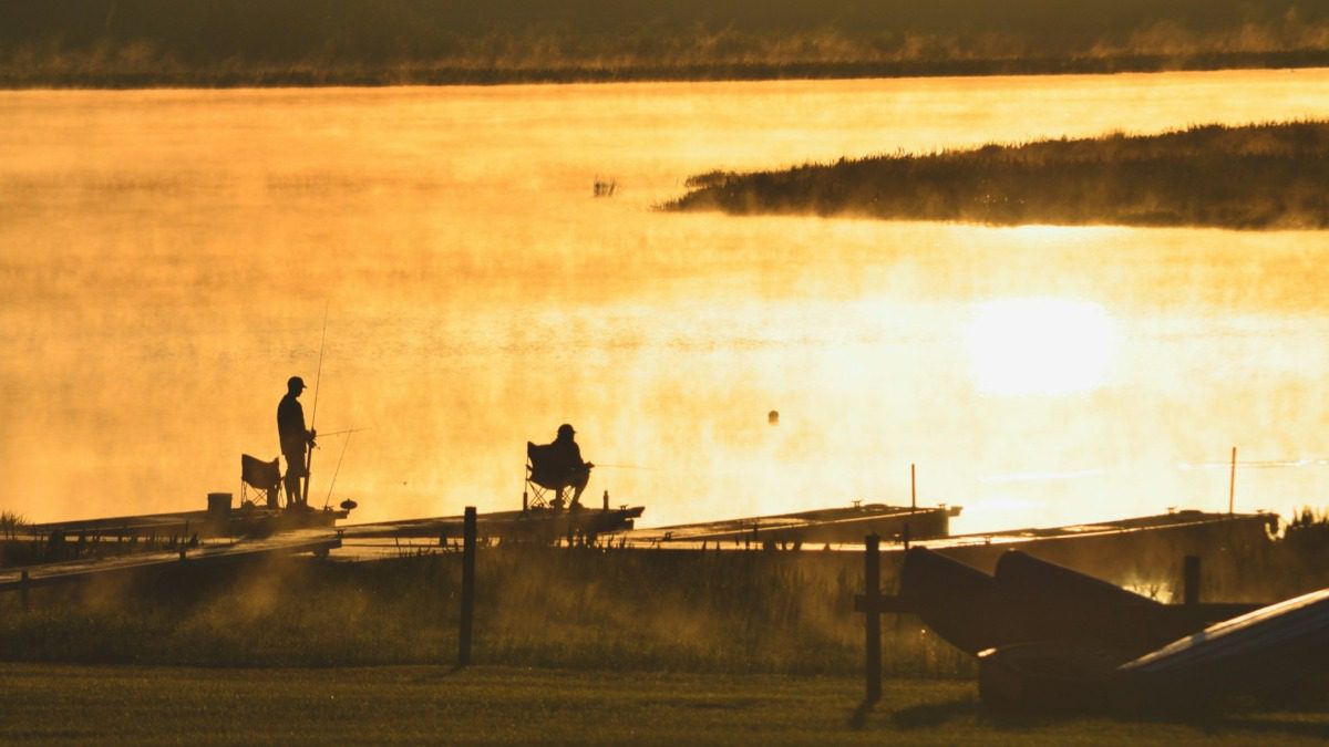 Two people fishing in the water near Naples, FL.